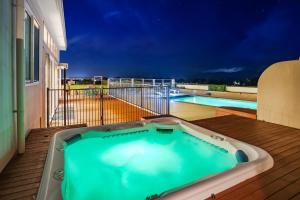 布伦海姆Mountainview Villa Luxury Lodge & Glamping的游泳池旁甲板上的热水浴池