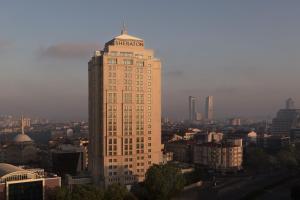 伊斯坦布尔Sheraton Istanbul Levent的一座高大的建筑,上面有标志