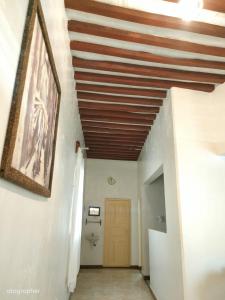 拉穆Manama Suites Apartment的走廊上设有木制天花板和门
