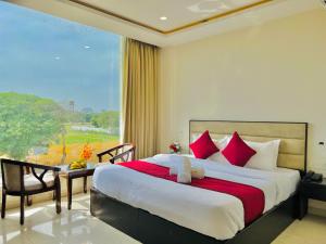 齐拉克普尔Stay @Northview park hotel zirakpur的一间卧室设有一张大床和一个大窗户
