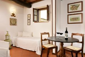 蒙特里久尼蒙特里基欧尼浪漫酒店的一间房间,配有一张桌子和两杯葡萄酒