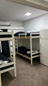 卡塔马卡NORTE HOSTEL的客房设有三张双层床和一台冰箱。