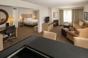 泰格德提加波特兰希尔顿逸林酒店的酒店客房设有床和客厅。