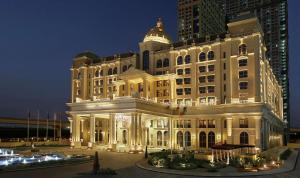 迪拜Al Habtoor Palace的一座在晚上有灯的大建筑