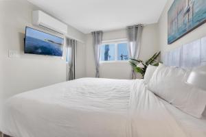 奥欣赛德Tower 9 #6的白色的卧室设有一张白色大床和一个窗户。