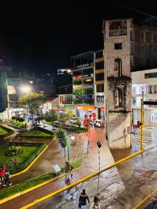 安达韦拉斯LUX - HOTEL BOUTIQUE的夜间与自行车上的人一起在城市街道上
