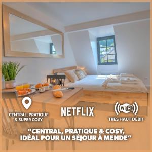 芒德Le Rustique - Netflix/Wi-fi Fibre - Séjour Lozère的一间卧室配有一张床和一张带镜子的桌子