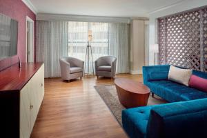 迪凯特亚特兰大迪凯特市中心/埃默里万怡酒店的客厅配有蓝色的沙发和椅子