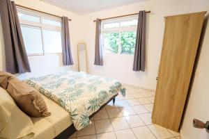 TohautuNoha Lodge的一间卧室设有一张床和两个窗户。