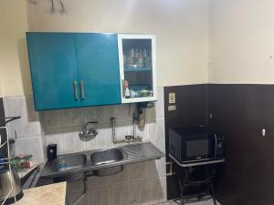 开罗Beautiful apartment in the heart of cairo的厨房配有水槽和蓝色橱柜