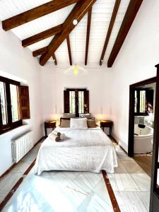 格拉纳达Hotelito Suecia的一间白色卧室,配有床和一间浴室