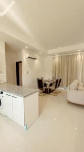 Wādī KhasbarHawana VIP Private Apartment的白色的客厅设有厨房和桌子