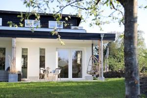 BeersStijlvol huisje met veranda! Tuynloodz C的白色的房子,有黑色的屋顶和椅子