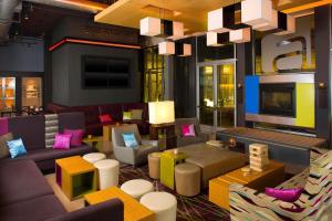 绿湾绿湾酒店的酒店大堂设有色彩缤纷的家具和电视。