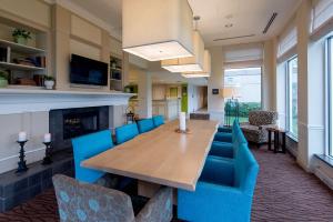 奥因斯米尔斯希尔顿奥因斯米尔斯花园酒店（Hilton Garden Inn Owings Mills）的一间带桌子和蓝色椅子的用餐室
