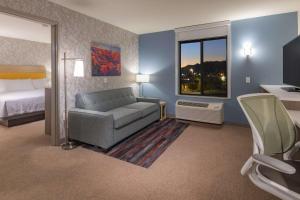 金曼金曼希尔顿欣庭套房酒店的一间配有沙发、一张床和窗户的客房