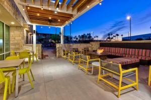土桑Home2 Suites By Hilton Tucson Airport, Az的一个带桌椅和火坑的庭院