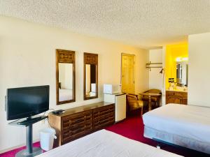 索科罗San Miguel Inn的酒店客房设有两张床和一台平面电视。