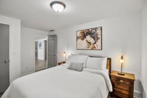 亚特兰大Spacious & Charming House in Heart of Atlanta的白色卧室设有一张大床和镜子