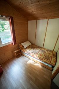 阿斯顿帕熊度假屋的小屋内的小卧室,配有床铺