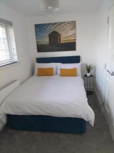 利马瓦迪Binevenagh View, Magilligan Holiday Let的一间卧室配有一张带黄色枕头的大床