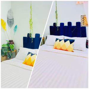 罗夷Sisters的一间卧室配有两张带色彩缤纷枕头的床