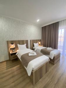 奇姆肯特KORKEM Palace Hotel and Spa的酒店客房设有两张床和窗户。