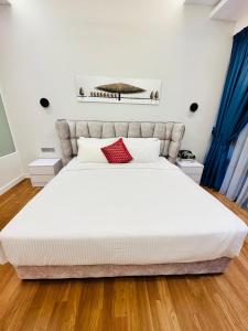 吉隆坡Anggun Residence KL by F&F的卧室配有带红色枕头的大型白色床