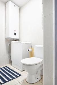 瑟堡La Saline - Second Souffle - Cherbourg的浴室设有白色卫生间和蓝色地毯。