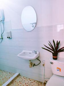 琅勃拉邦天堂鸟花园客栈的一间带水槽、卫生间和镜子的浴室