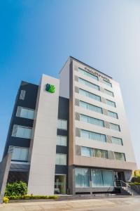 利马圣米格尔帕尔梅托商务酒店的上面有绿色标志的高楼
