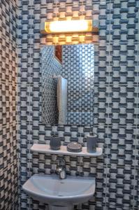 雅温得LES LOGIS DE NOUVELLE ROUTE BASTOS的一间带水槽和镜子的浴室