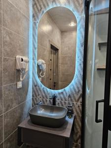阿拉木图DeLuxe Apartments的一间带水槽和镜子的浴室