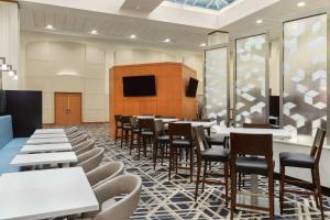 波士顿波士顿洛根机场使馆套房酒店的一间带桌椅和电视的用餐室
