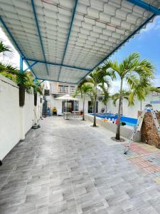 普拉亚斯Casa Halley #4 con vista al mar y piscina , 2 pisos - Villamil Playas , Data de Villamil的棕榈树庭院和建筑