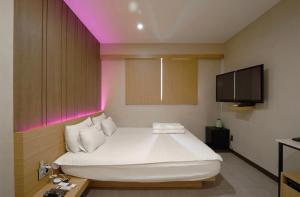 Nampo Comma Hotel客房内的一张或多张床位