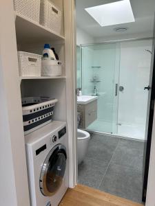 MahiaOcean Waters的一间带洗衣机和淋浴的浴室