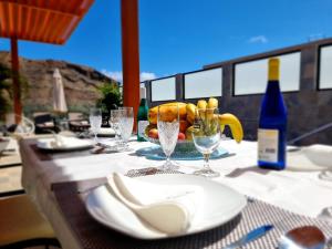 莫甘Villa de lujo con piscina climatizada的一张桌子上放有盘子和酒杯