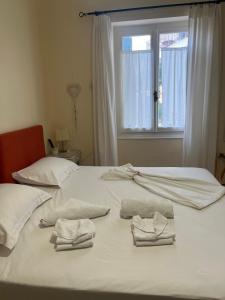 迈萨纳艾里德一室公寓的白色床上的两条毛巾,带窗户