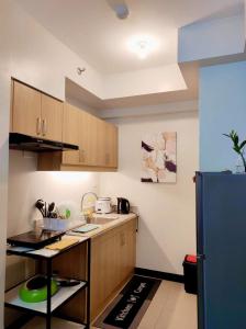 达沃市VERDON PARC CONDOMINIUM的厨房配有木制橱柜和蓝色冰箱。