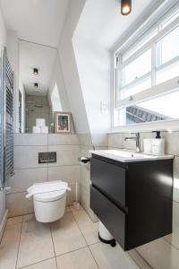 伦敦Notting Hill Apartments Collection的一间带卫生间、水槽和窗户的浴室