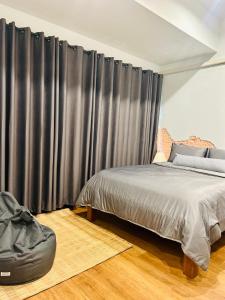 清迈Chern Chiangmai Boutique Hotel的一间卧室配有床和黑色窗帘