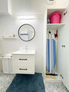 赖阿南纳lovely apartment in Ra'anana的白色的浴室设有水槽和镜子