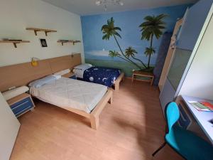 La casa de riki的一间卧室配有两张床,并画有棕榈树