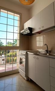 马尔萨拉VersoSUD的一间厨房,配有白色家电和大窗户