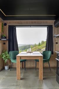 StangeHide Hut - Amazing view 50 min from Oslo的带大窗户的厨房内的桌椅