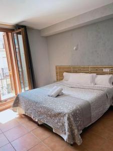 哈卡Hotel Acebo Plaza Mayor的一间卧室配有一张大床和木制床头板