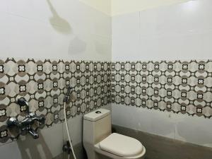 商沙巴Hotel Plaza Airport Zone的一间带卫生间的浴室和面部壁纸