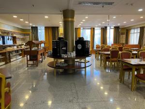 布达佩斯布达佩斯埃克托酒店的一间带桌椅和壁炉的餐厅