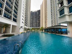 莎阿南Trefoil Studio Comfy 3-Shah Alam的一座大型游泳池,位于部分建筑的中间
